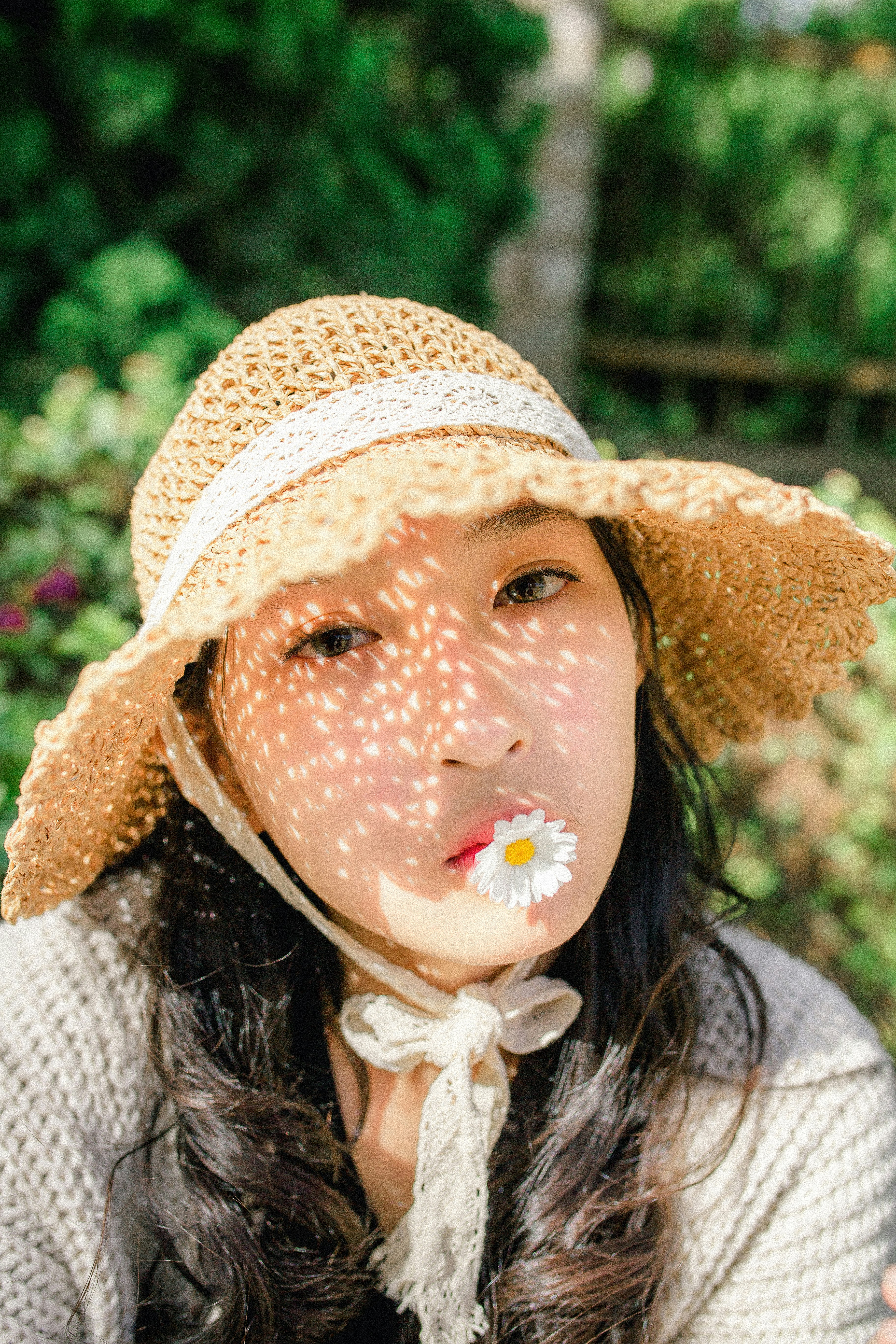 woman wearing sun hat in flower garden